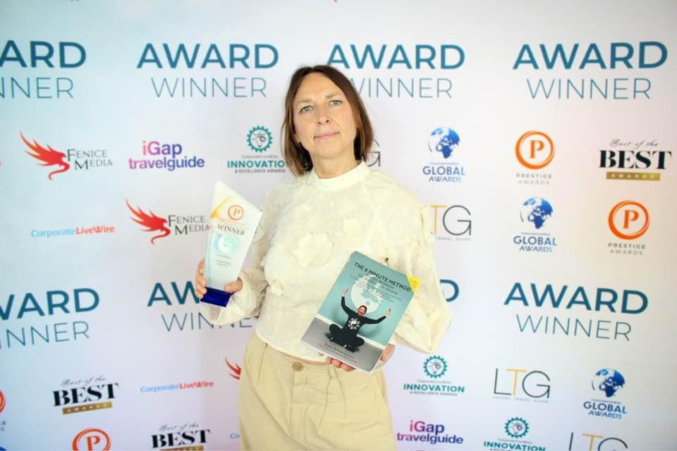 Jenna Robins receiving her Acupuncturist of the Year award, pictured with her 6 Minute Method book